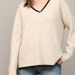 Oatmeal V-neck sweater with black trim, three-quarter view