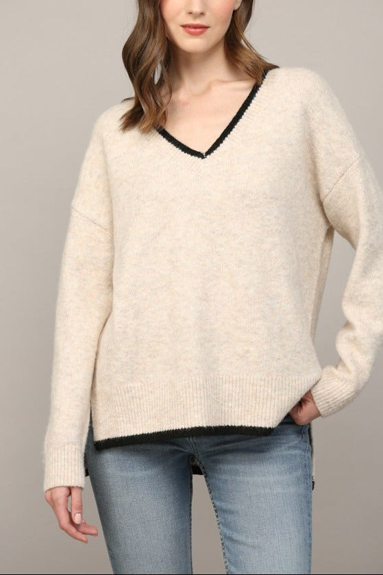 Oatmeal V-neck sweater with black trim, three-quarter view