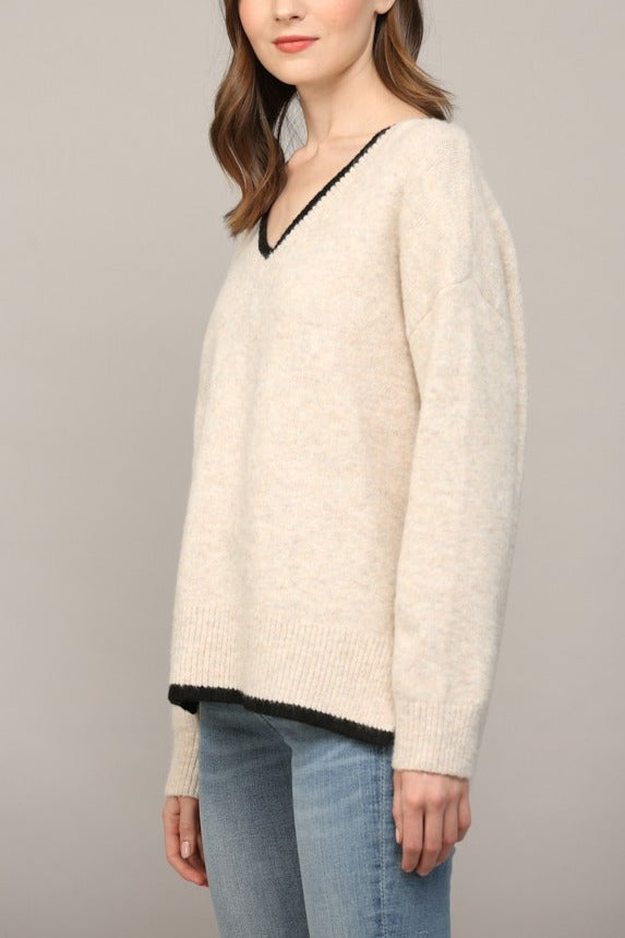 Oatmeal V-neck sweater side view showing high-low hem