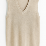 Beige ribbed knit vest on a white background