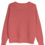 Rose colored women's sweater on white background