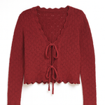 Red knitted cardigan with lace-up front on a white background