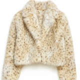 Fluffy beige jacket on a white background