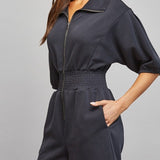 Sloane Zip Front Smocked Romper in Black - side view with pocket