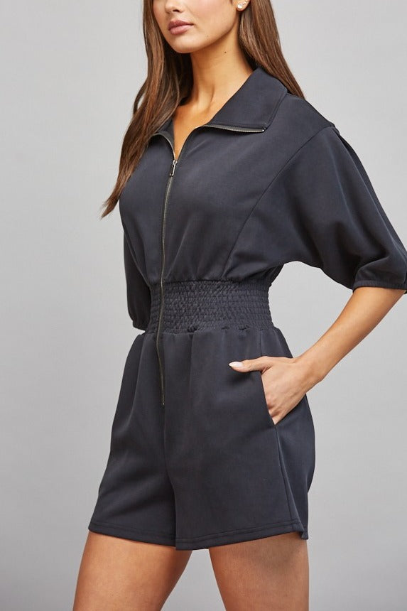 Sloane Zip Front Smocked Romper in Black - side view with pocket