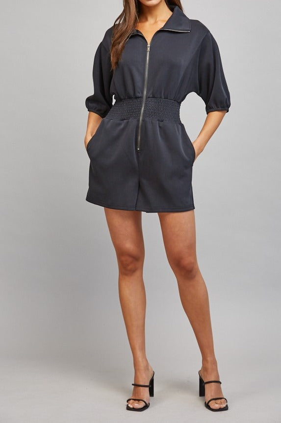 Sloane Zip Front Smocked Romper in Black - full length styled with heels