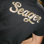Man wearing the Seager Russ Fill Tee in Black, back graphic