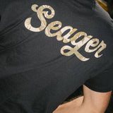 Man wearing the Seager Russ Fill Tee in Black, back graphic
