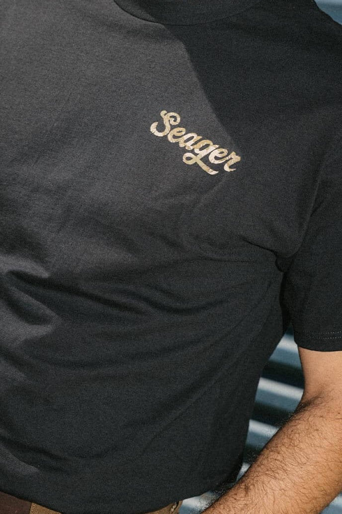 Man wearing the Seager Russ Fill Tee in Black, front view