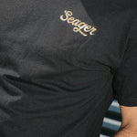 Man wearing the Seager Russ Fill Tee in Black, front view