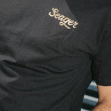 Man wearing the Seager Russ Fill Tee in Black, front view