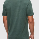 Man wearing a green t-shirt on a light gray background