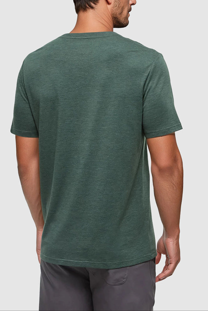 Man wearing a green t-shirt on a light gray background