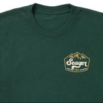 Close up of the High Country chest graphic on the forest green tee