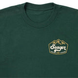 Close up of the High Country chest graphic on the forest green tee
