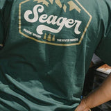 Man wearing the Seager High Country Tee in Forest Green, back graphic