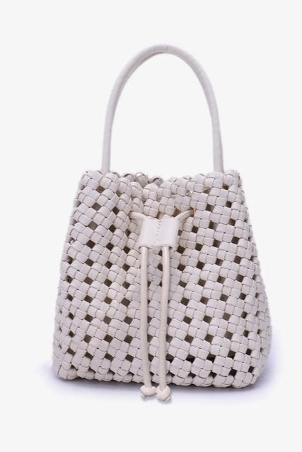 Woven handbag with drawstring on a white background