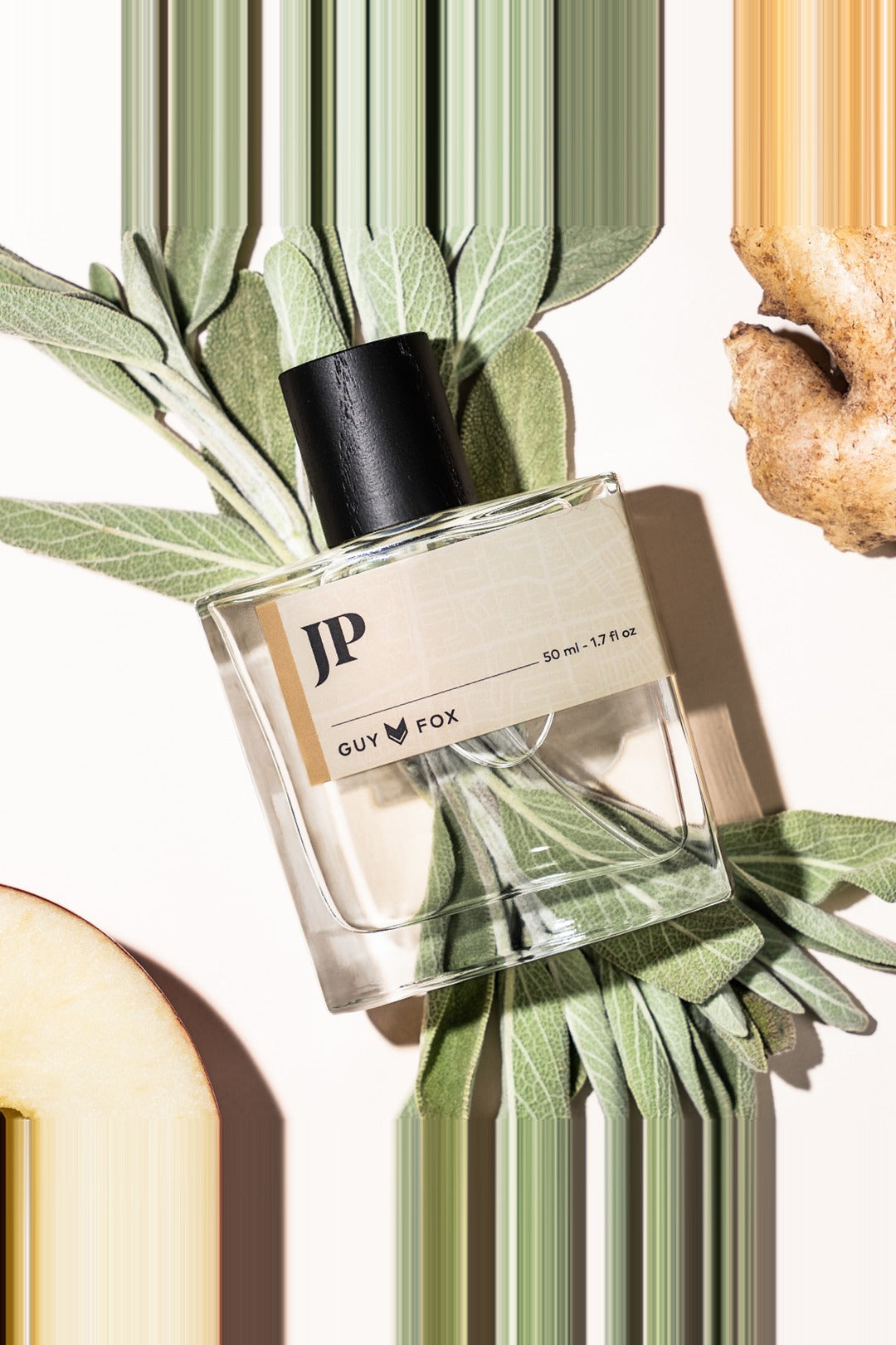 Guy Fox JP cologne bottle flat lay with fresh ginger and sage