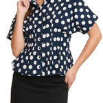 Woman wearing a navy blue blouse with white polka dots and a black skirt on a transparent background