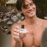 Man holding Kuya cologne on a tropical beach