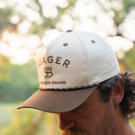 Man wearing the Seager Branded Snapback in cream and brown