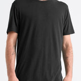 Man wearing a black t-shirt and blue jeans on a white background