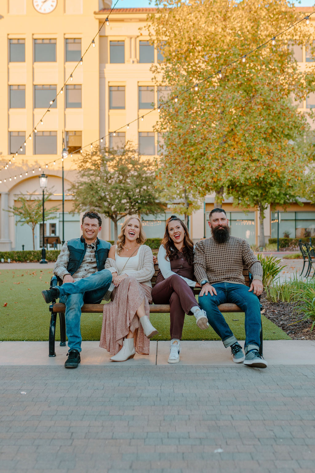 Friends sitting on a bench in a shopping center in the fall in a shopping center