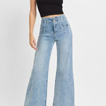 Woman wearing a black tank top and light blue jeans on a white background