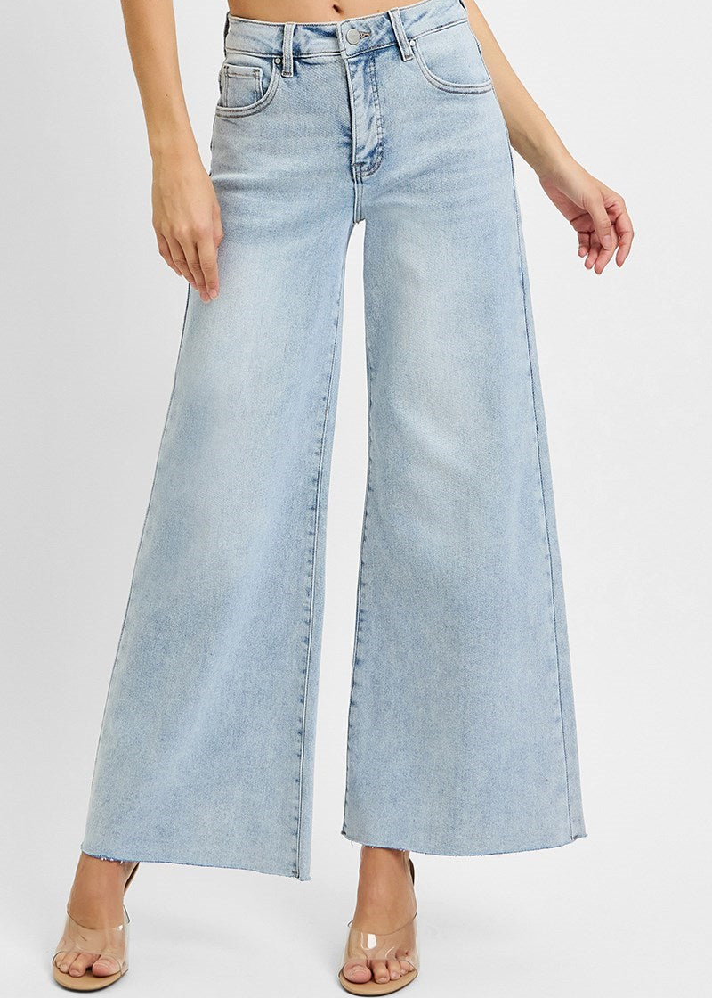 Light blue wide-leg jeans worn by a person on a white background