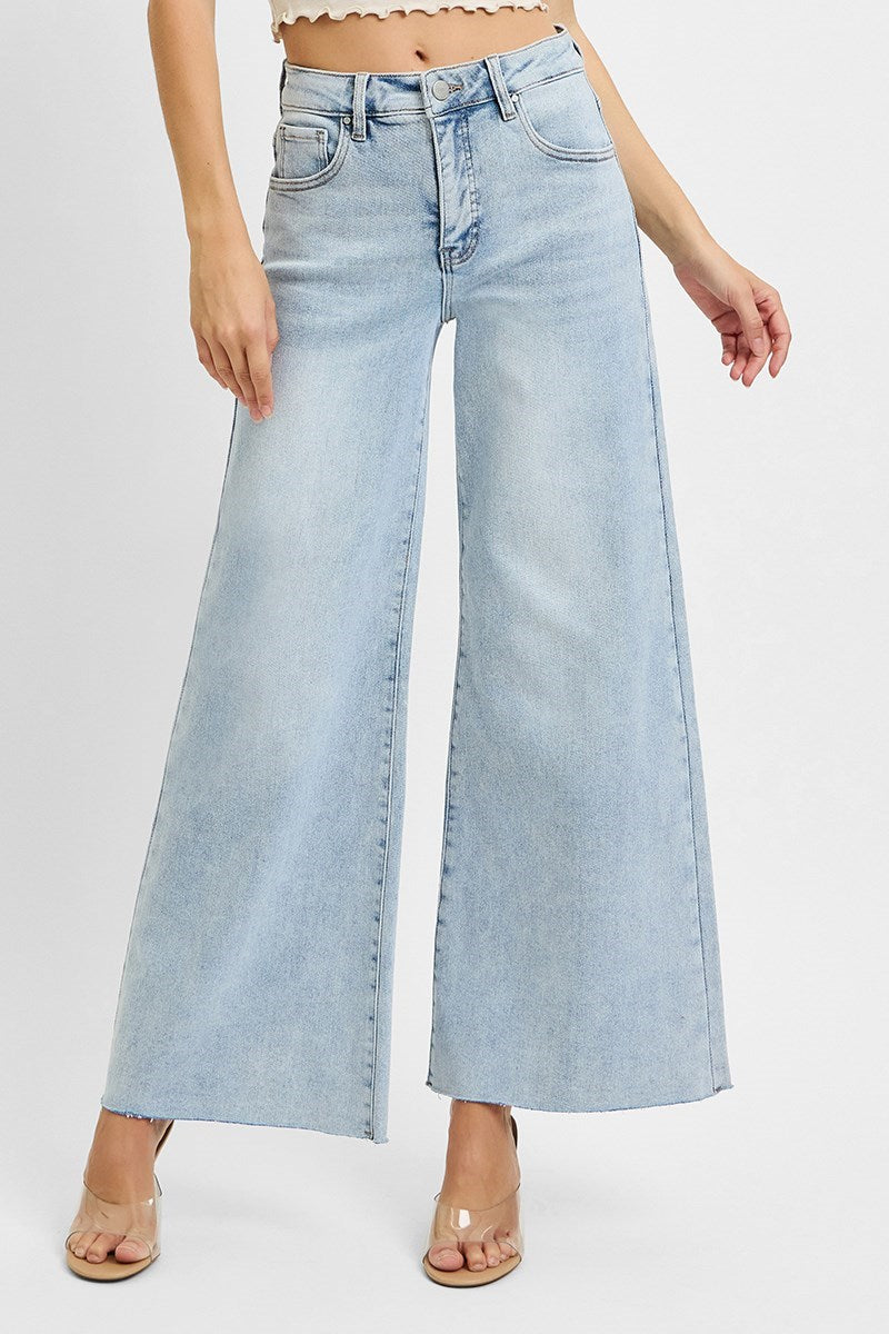 Light blue wide-leg jeans worn by a person on a white background