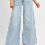 Light blue wide-leg jeans worn by a person on a white background