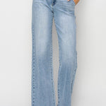 Light blue jeans worn by a person on a white background