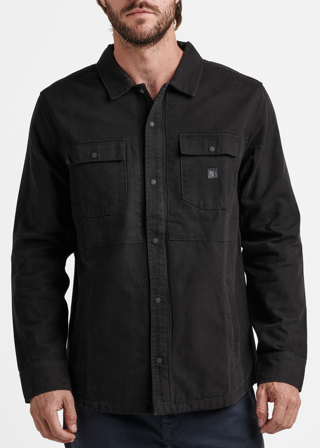 Man wearing a black shirt with a collar on a white background