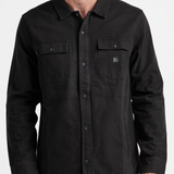 Man wearing a black shirt with a collar on a white background