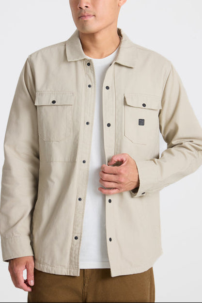 Man wearing a beige jacket on a white background