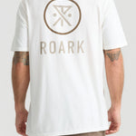 Man wearing white Roark Safe Camp XL Premium Tee with logo on back