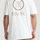Man wearing white Roark Safe Camp XL Premium Tee with logo on back