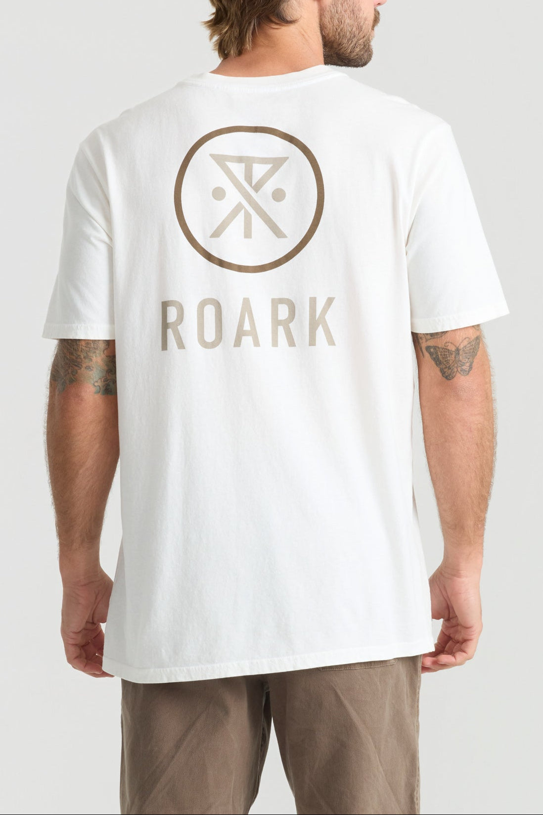 Man wearing white Roark Safe Camp XL Premium Tee with logo on back