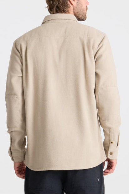 Man wearing a beige shirt on a white background