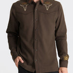 Man wearing a brown embroidered shirt on a white background