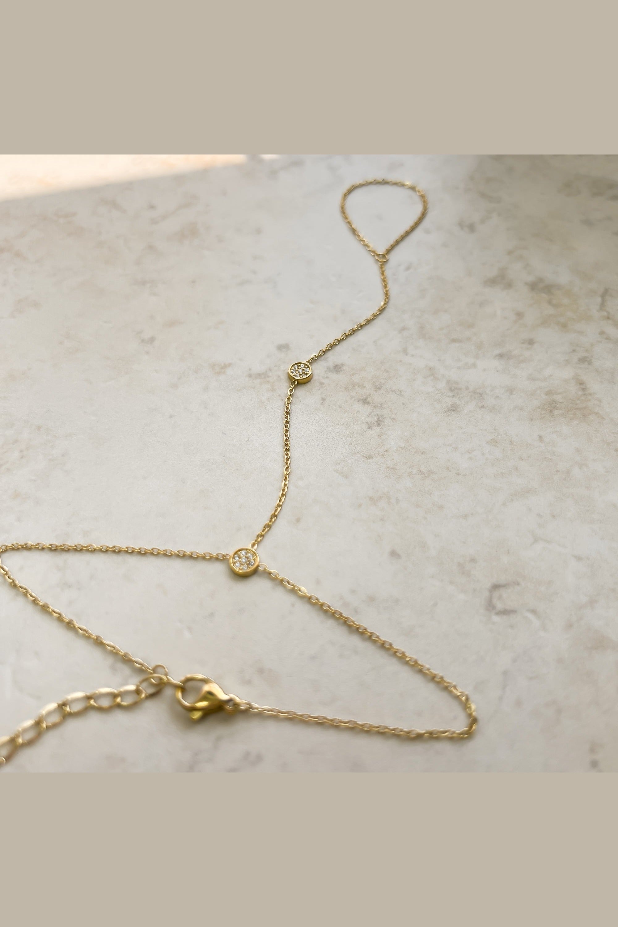 Dainty cubic zirconia hand chain worn on the hand
