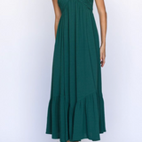 Green halter neck dress with ruffled hem on a white background