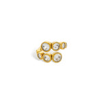 Gold ring with staggered row of bezel-set cubic zirconia
