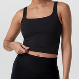 Woman wearing a black athletic outfit on a white background