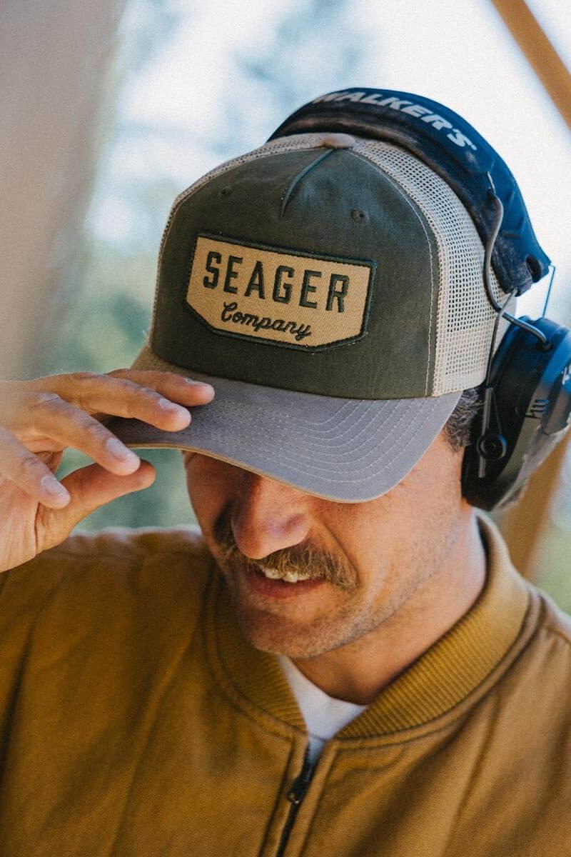 Man wearing the Seager Wilson Waxed Snapback in Tan and Green