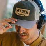 Man wearing the Seager Wilson Waxed Snapback in Tan and Green