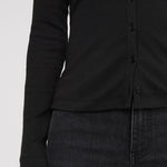Black button-up shirt worn by a person on a white background