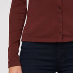 Brown button-up shirt worn by a person on a white background