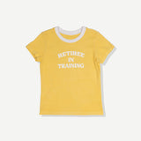 Yellow baby tee with white trim and 'RETIREE IN TRAINING' text on front