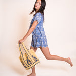 Z&L Europe Serena Shorts in blue embroidered cotton worn with the matching top and a straw bag